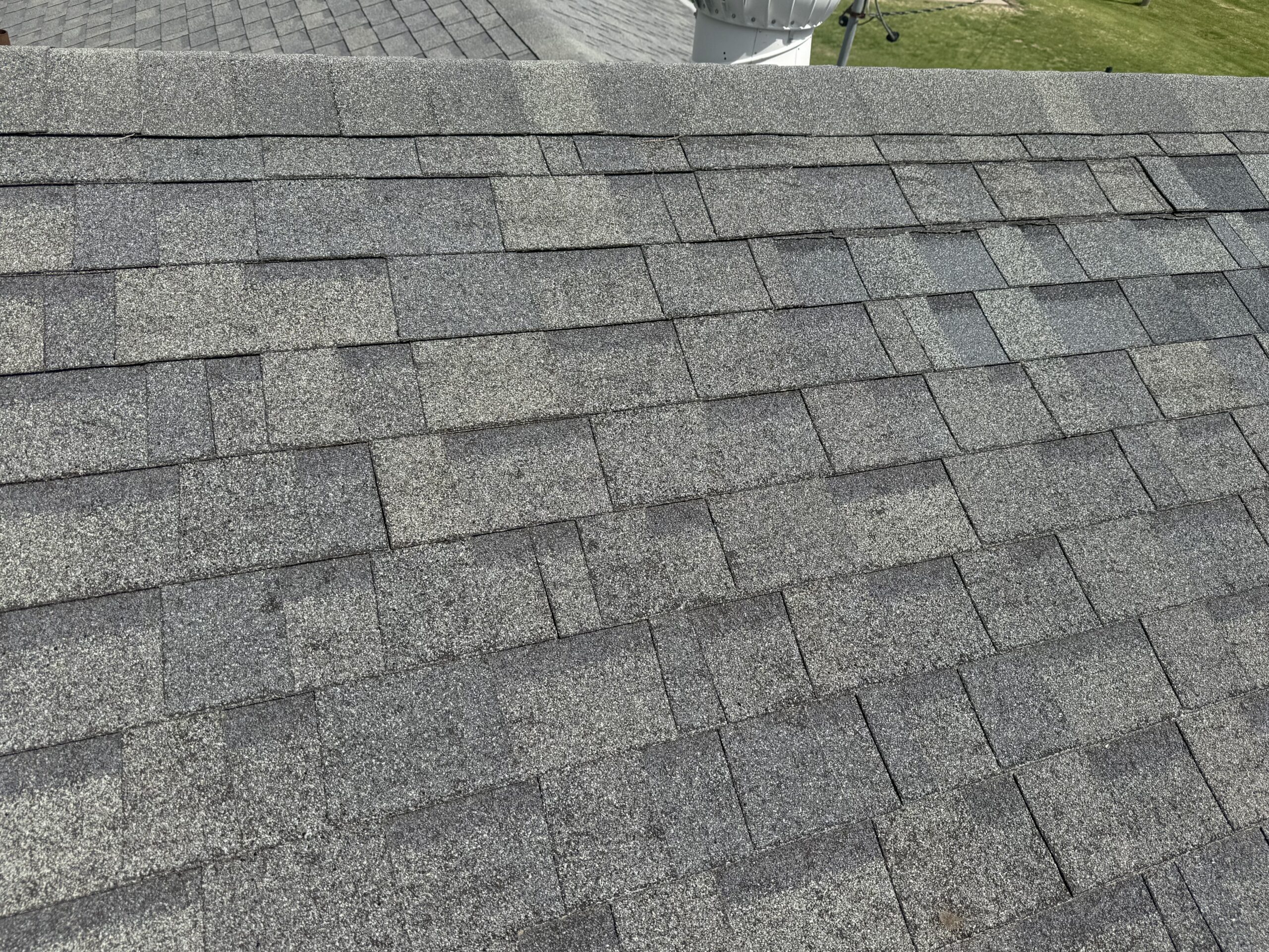 Up close image of asphalt shingles that have sustained hail damage